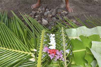 Fijian cooking food underground at a lovo 